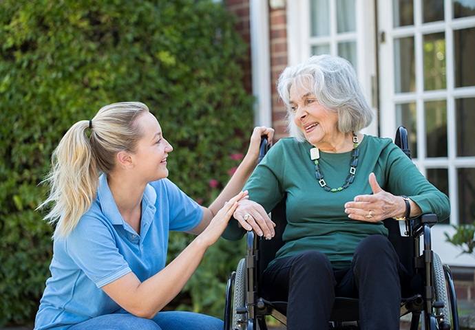 social care professional speaking to woman in wheelchair